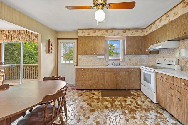 95 Flagg Ave, Watertown, CT 06779 - kitchen featuring white electric stove, under cabinet range hood, tasteful backsplash, and light countertops