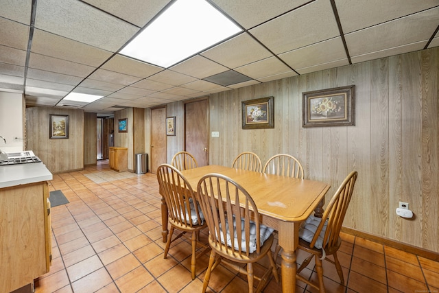 95 Flagg Ave, Watertown, CT 06779 - dining area featuring a drop ceiling, wood walls, and light tile patterned floors