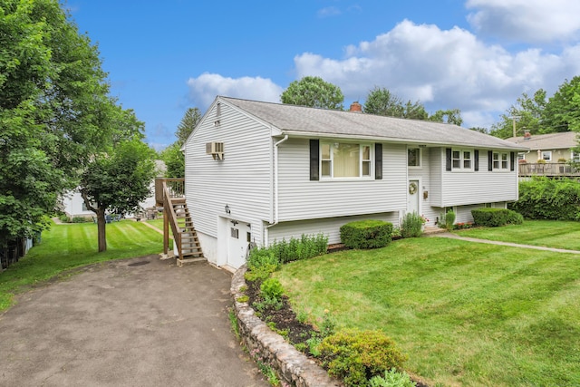 95 Flagg Ave, Watertown, CT 06779 - split foyer home featuring stairway, a chimney, a front yard, and asphalt driveway