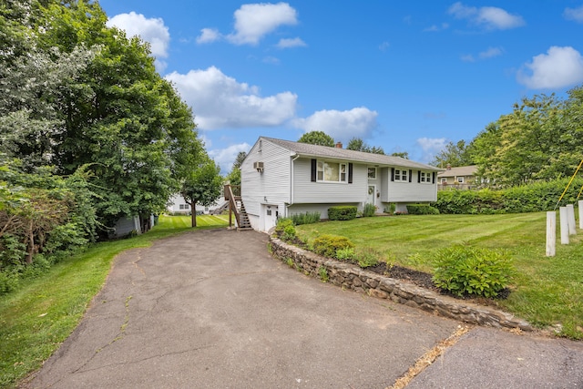 95 Flagg Ave, Watertown, CT 06779 - split foyer home featuring a chimney, a front lawn, a garage, stairway, and driveway
