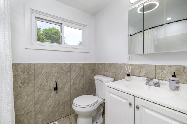 207 Hillcrest Rd, Bridgeport, CT 06606 - full bathroom featuring tile walls, vanity, a wainscoted wall, and curtained shower