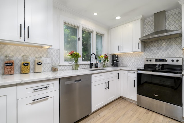 207 Hillcrest Rd, Bridgeport, CT 06606 - kitchen featuring appliances with stainless steel finishes, wall chimney range hood, ornamental molding, light stone counters, and white cabinetry