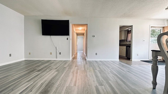 55 Thompson St Unit 17H, East Haven, CT 06513 - unfurnished living room featuring wood finished floors and a textured ceiling