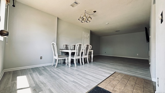 55 Thompson St Unit 17H, East Haven, CT 06513 - dining space with wood finished floors and a textured ceiling