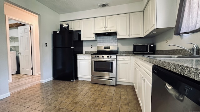 55 Thompson St Unit 17H, East Haven, CT 06513 - kitchen with appliances with stainless steel finishes, white cabinetry, dark countertops, under cabinet range hood, and a textured ceiling