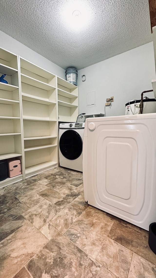 55 Thompson St Unit 17H, East Haven, CT 06513 - washroom featuring a textured ceiling, washing machine and clothes dryer, and stone finish floors