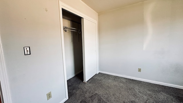 55 Thompson St Unit 17H, East Haven, CT 06513 - unfurnished bedroom featuring dark colored carpet and a closet