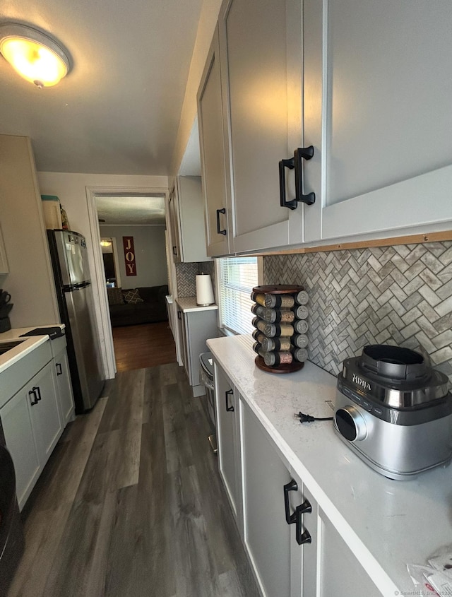 744 Canaan Rd Unit 23, Bridgeport, CT 06610 - kitchen with freestanding refrigerator, tasteful backsplash, light countertops, and dark wood-style floors