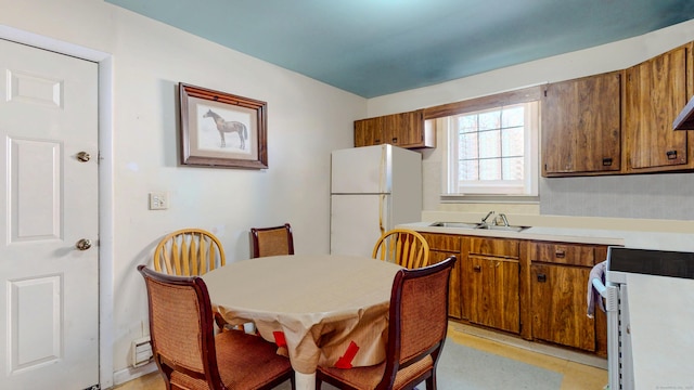 96 Davis Ave, Bridgeport, CT 06605 - kitchen with freestanding refrigerator, range, brown cabinets, and light countertops