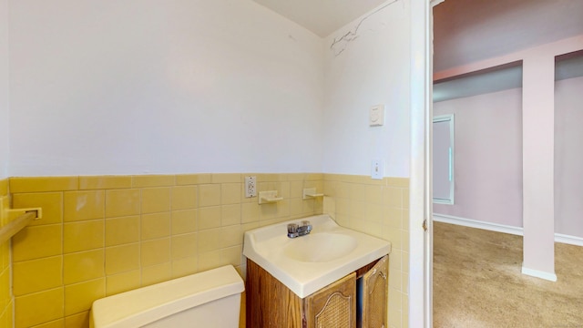96 Davis Ave, Bridgeport, CT 06605 - half bathroom with vanity, tile walls, and a wainscoted wall