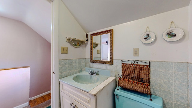 96 Davis Ave, Bridgeport, CT 06605 - half bathroom featuring tile walls, vanity, vaulted ceiling, wainscoting, and wood finished floors