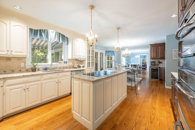 51 Wood Lot Ln, Southbury, CT 06488 - kitchen with wine cooler, a chandelier, black electric stovetop, healthy amount of natural light, and recessed lighting