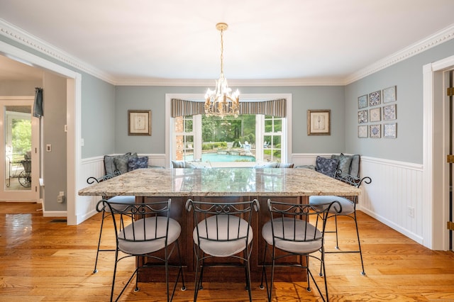51 Wood Lot Ln, Southbury, CT 06488 - dining space with light wood-type flooring, wainscoting, a chandelier, ornamental molding, and breakfast area