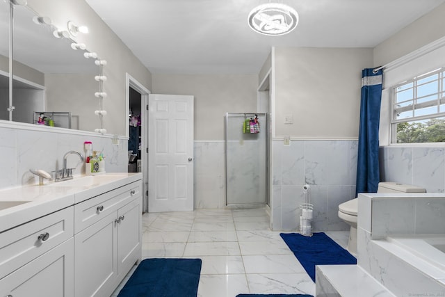 146 Whitewood Rd, Torrington, CT 06790 - full bathroom with marble look tiles, vanity, wainscoting, a tub with marble appearance, and tile walls