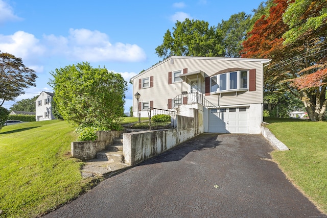 146 Williamson Cir, Watertown, CT 06779 - split foyer home featuring asphalt driveway, an attached garage, and a front lawn