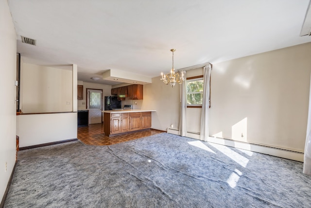 146 Williamson Cir, Watertown, CT 06779 - kitchen featuring freestanding refrigerator, dark carpet, a chandelier, light countertops, and brown cabinets