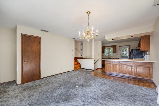 146 Williamson Cir, Watertown, CT 06779 - kitchen featuring freestanding refrigerator, a chandelier, carpet, light countertops, and a peninsula