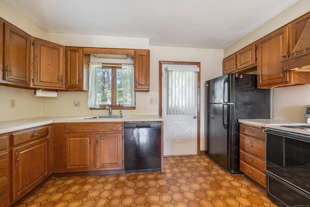 146 Williamson Cir, Watertown, CT 06779 - kitchen featuring black appliances, light countertops, wall chimney range hood, and brown cabinets