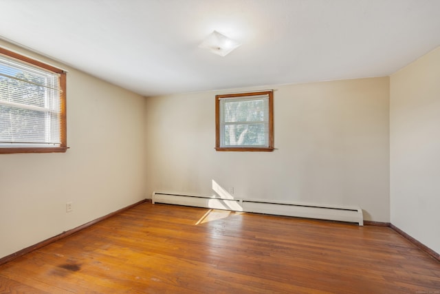 146 Williamson Cir, Watertown, CT 06779 - empty room featuring a baseboard heating unit and wood finished floors