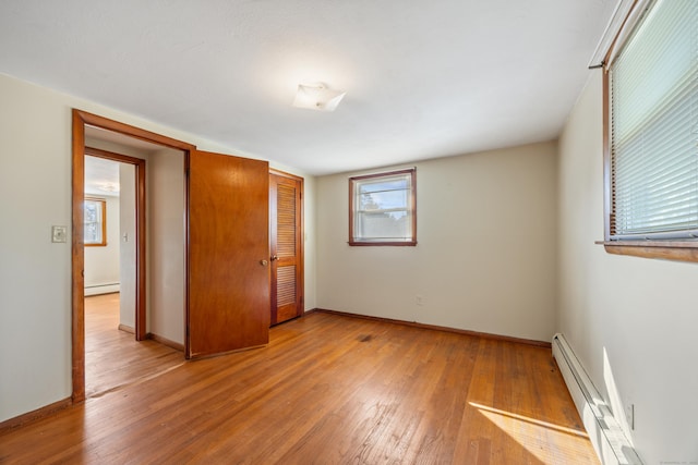 146 Williamson Cir, Watertown, CT 06779 - unfurnished bedroom featuring a baseboard heating unit, light wood finished floors, and a closet