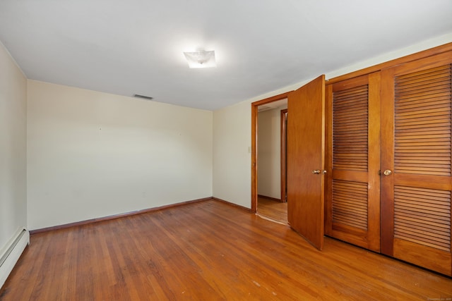 146 Williamson Cir, Watertown, CT 06779 - unfurnished bedroom featuring a baseboard radiator, a closet, and wood finished floors