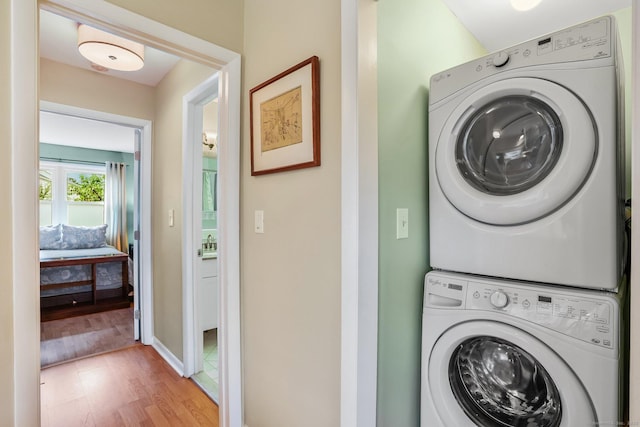 69 Ellsworth St Apt 101, Bridgeport, CT 06605 - laundry room featuring stacked washer / dryer and wood finished floors