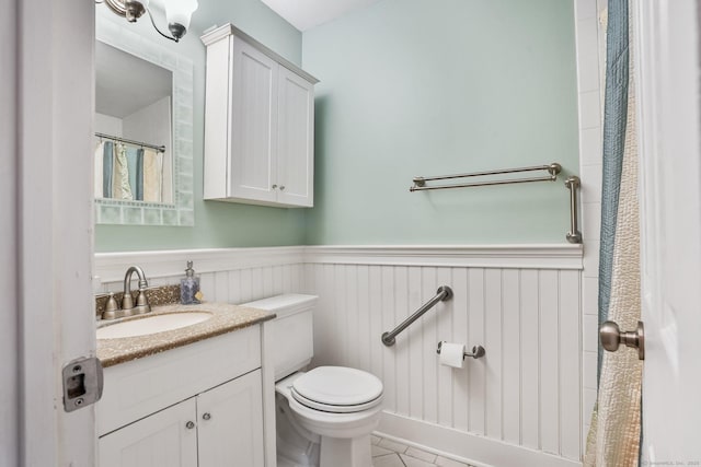 69 Ellsworth St Apt 101, Bridgeport, CT 06605 - full bath featuring a wainscoted wall, vanity, and tile patterned floors