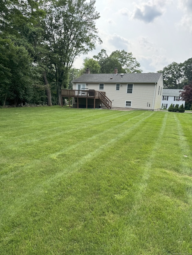 352 Knob Hill Dr, Hamden, CT 06518 - back of house featuring a wooden deck, stairs, a lawn, and a chimney