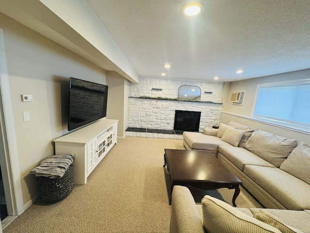 352 Knob Hill Dr, Hamden, CT 06518 - carpeted living area featuring a stone fireplace, a textured ceiling, recessed lighting, and a wall mounted AC