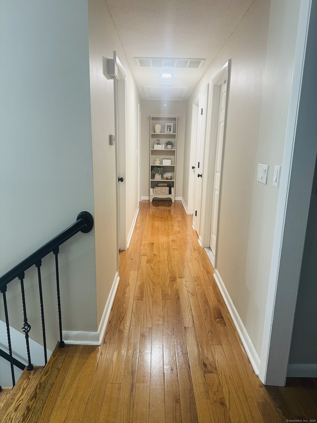 352 Knob Hill Dr, Hamden, CT 06518 - hallway featuring attic access, built in shelves, light wood-style flooring, and an upstairs landing