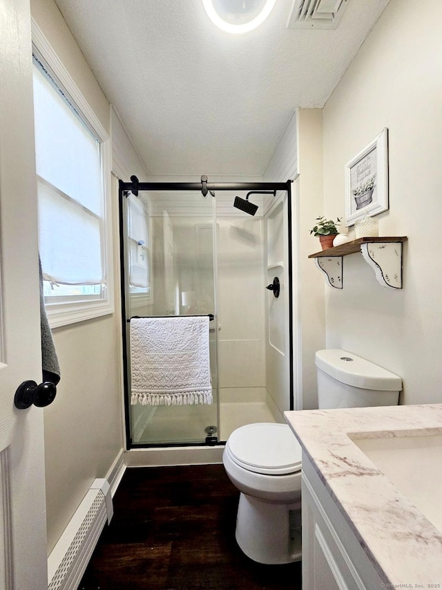 352 Knob Hill Dr, Hamden, CT 06518 - full bath featuring wood finished floors, a shower stall, vanity, and baseboard heating