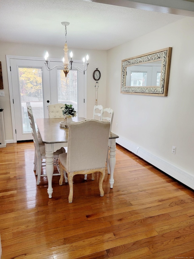 352 Knob Hill Dr, Hamden, CT 06518 - dining area featuring a chandelier, light wood-style floors, and baseboard heating