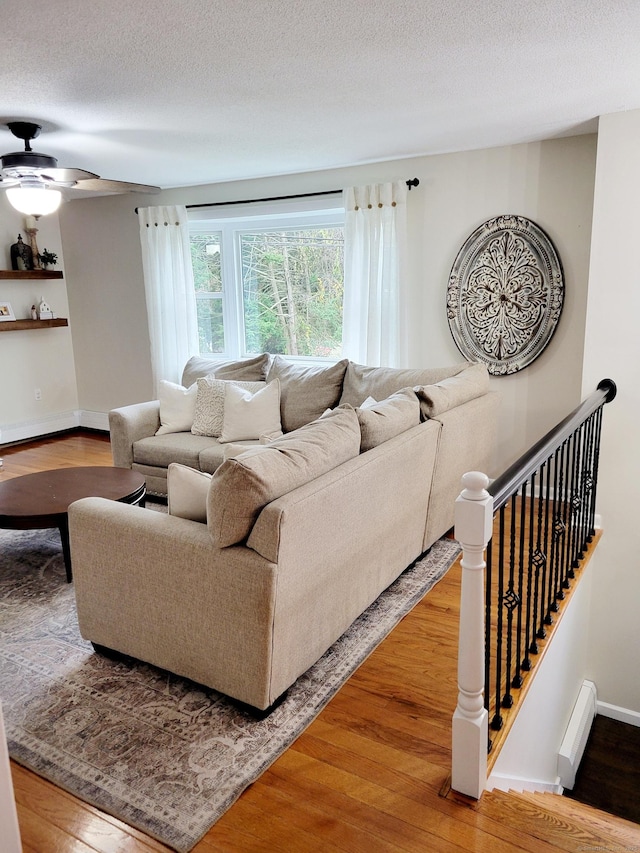 352 Knob Hill Dr, Hamden, CT 06518 - living area with wood finished floors, a ceiling fan, baseboard heating, and a textured ceiling