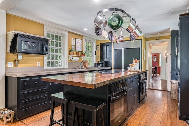 85 Potash Hill Rd, Sprague, CT 06330 - kitchen with wood counters, dark cabinets, black appliances, ornamental molding, and a kitchen island