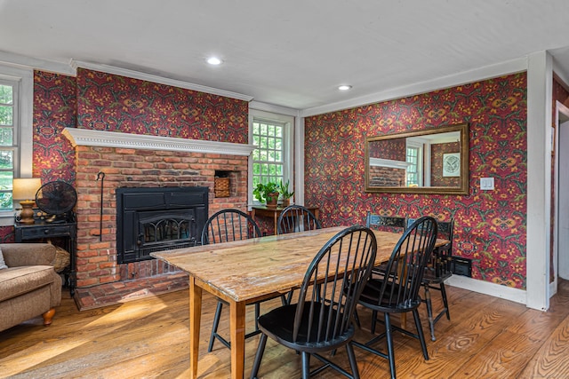 85 Potash Hill Rd, Sprague, CT 06330 - dining room featuring wood finished floors, healthy amount of natural light, wallpapered walls, a fireplace, and crown molding