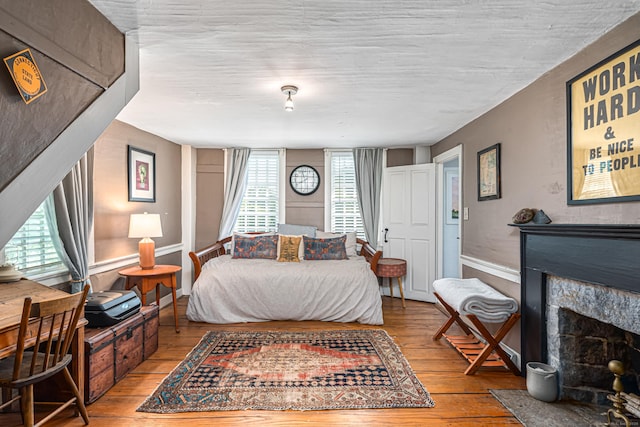 85 Potash Hill Rd, Sprague, CT 06330 - bedroom featuring wood-type flooring and a fireplace