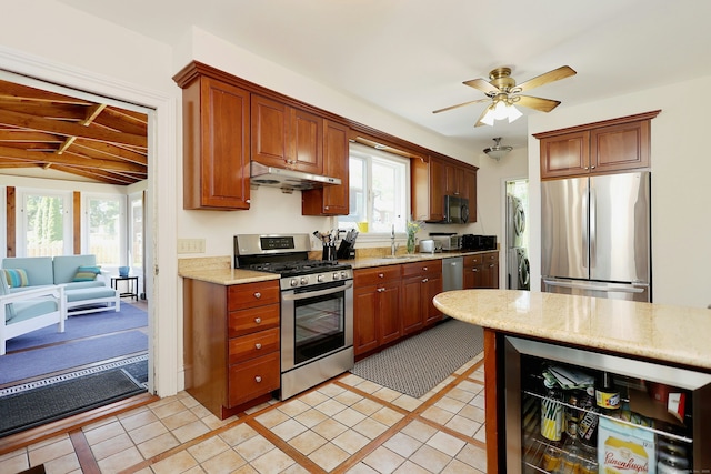 30 Elizabeth St, Bethel, CT 06801 - kitchen with stainless steel appliances, beverage cooler, stacked washer and clothes dryer, under cabinet range hood, and plenty of natural light