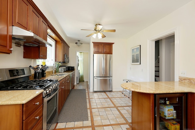 30 Elizabeth St, Bethel, CT 06801 - kitchen featuring stainless steel appliances, under cabinet range hood, a ceiling fan, and light stone counters