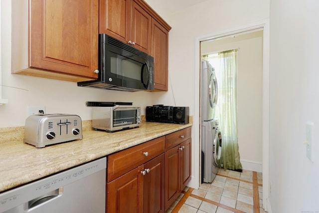 30 Elizabeth St, Bethel, CT 06801 - kitchen with black microwave, dishwasher, stacked washing machine and dryer, brown cabinetry, and light tile patterned floors