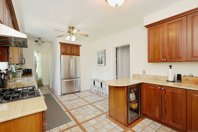30 Elizabeth St, Bethel, CT 06801 - kitchen with freestanding refrigerator, a ceiling fan, extractor fan, a peninsula, and wine cooler