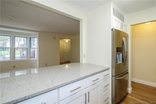 95 Audubon St Unit 339, New Haven, CT 06510 - kitchen featuring stainless steel fridge with ice dispenser, white cabinets, light stone countertops, and light wood-style flooring