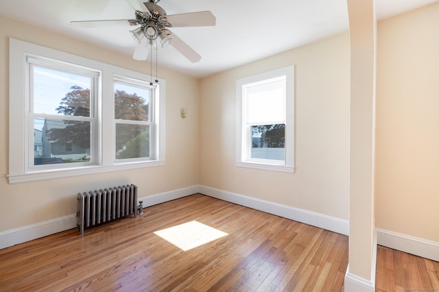 15 Magnolia Ave, Bristol, CT 06010 - empty room featuring radiator, hardwood / wood-style flooring, and a ceiling fan