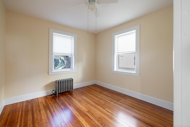 15 Magnolia Ave, Bristol, CT 06010 - empty room featuring radiator heating unit, wood-type flooring, and a ceiling fan