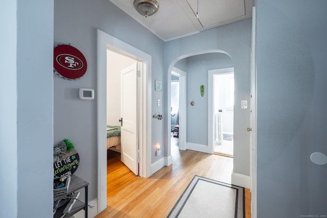 15 Magnolia Ave, Bristol, CT 06010 - corridor featuring light wood finished floors, arched walkways, and attic access