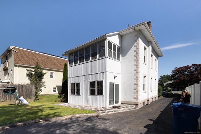 15 Magnolia Ave, Bristol, CT 06010 - rear view of property featuring a chimney and board and batten siding
