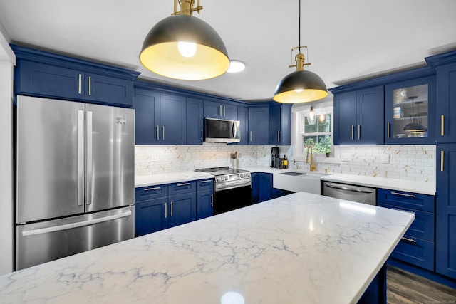 216 Old Monson Rd, Stafford, CT 06076 - kitchen featuring stainless steel appliances, blue cabinetry, decorative backsplash, glass insert cabinets, and light stone countertops