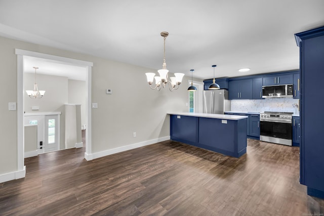 216 Old Monson Rd, Stafford, CT 06076 - kitchen with appliances with stainless steel finishes, a chandelier, blue cabinets, a peninsula, and healthy amount of natural light