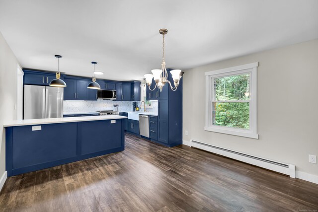 216 Old Monson Rd, Stafford, CT 06076 - kitchen with a baseboard heating unit, stainless steel appliances, blue cabinets, a chandelier, and light countertops