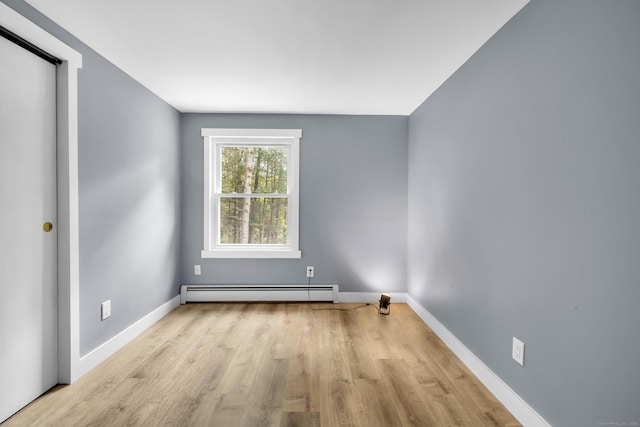 216 Old Monson Rd, Stafford, CT 06076 - spare room with a baseboard heating unit and wood finished floors