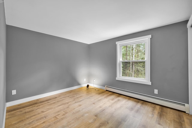 216 Old Monson Rd, Stafford, CT 06076 - empty room featuring a baseboard heating unit and wood finished floors
